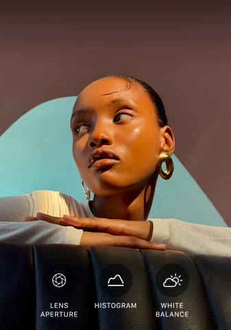 Close-up portrait of a well-lit model with a colourful background, demonstrating the pro camera system’s Pro controls UI: Lens Aperture, Histogram, White Balance