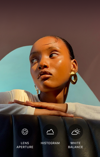 Close-up portrait of a well-lit model with a colourful background, demonstrating the pro camera system’s Pro controls UI: Lens Aperture, Histogram, White Balance