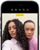 iPhone 18 Pro, black, front exterior, displaying two models posing for the camera, demonstrating the Center Stage front camera